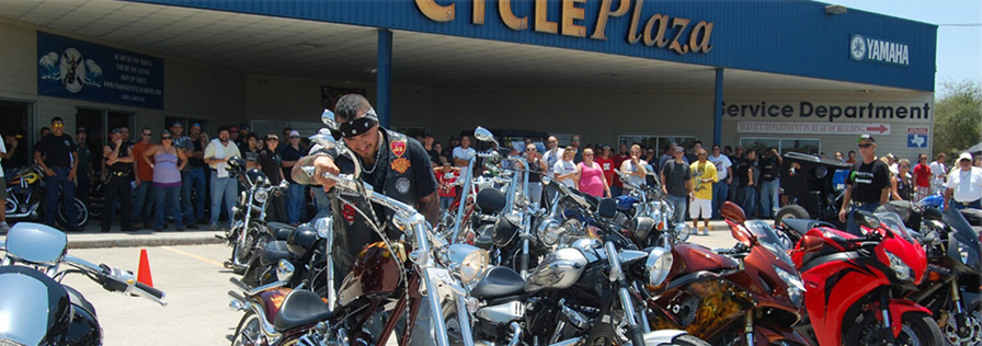 About Corpus Christi Cycle Plasa powersports dealer banner with motorcycles lined up in front of the powersports dealership